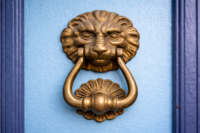 lion door knocker on a blue painted door